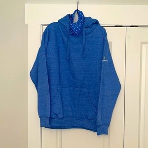 Discovery+ size large hoodie with built in mask light blue in color.